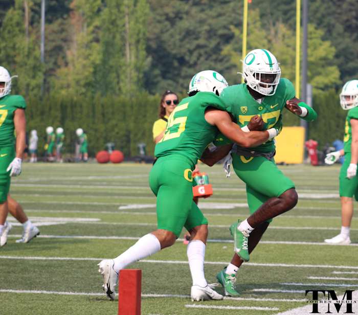 Bennett Williams wraps up Verone McKinley III in tackling drills.